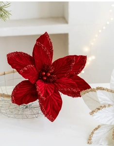 Close-up of velvet poinsettia flowers with glitter edges for Christmas tree decoration