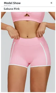 Detail of high-waist yoga shorts in sakura pink with white piping and side pockets