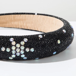 Macro detail of padded headband with black beads and sparkling star-shaped crystals