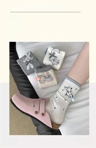 Detail of four mid-calf cotton socks with cartoon animals and 3D bow decorations