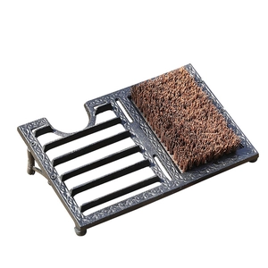 Vintage cast iron shoe scraper and boot brush with decorative floral relief frames