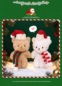 Close-up of Christmas plush bears with festive hats on artificial snow setting