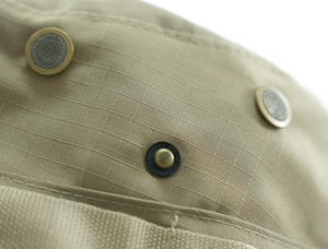 Macro detail of khaki ripstop sun hat featuring metal mesh vents and brass snap button