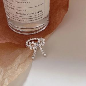 Elegant S925 sterling silver beaded bow ring shown against a vintage lifestyle background