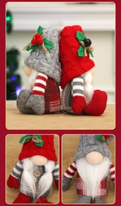 Close-up of red and grey Christmas gnomes with knitted hats and holly berry details