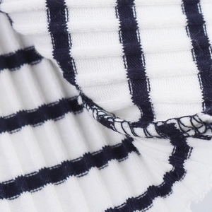 Macro shot of blue and white striped ribbed knit fabric showing detailed stitching and texture