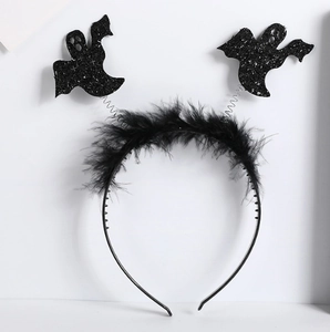 Detail of Halloween headband with black ostrich feathers and glitter ghost icons on springs