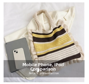 Macro shot of hand-knitted striped tote bag capacity showing tablet and phone