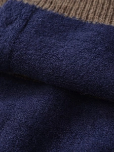 Close-up of navy knit fabric and brown ribbed polo collar texture with fuzzy wool detail