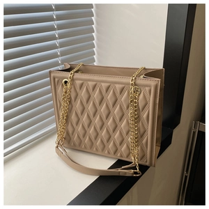 Detail of khaki quilted tote bag with chain strap and premium faux leather texture