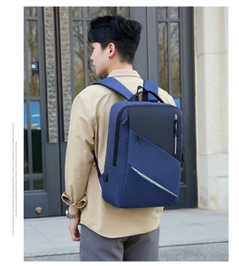 Blue business laptop backpack with side USB charging port shown on a model's back