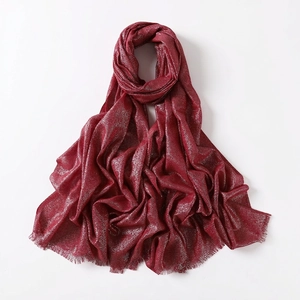 Detail of burgundy cotton scarf featuring shiny silver metallic lurex and frayed edges