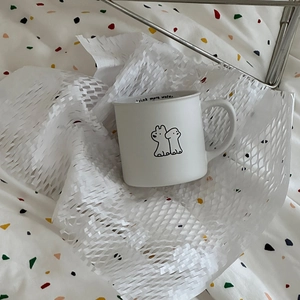 Detail of white ceramic puppy mug featuring 'drink more water' text inside the rim