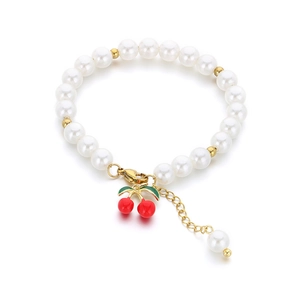 Sweet pearl beaded bracelet with gold accents and a red cherry fruit charm pendant