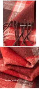 Detailed view of red and brown plaid scarf featuring handmade tassels and soft knit texture