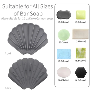 Grey shell-shaped silicone soap dish shown with compatibility for various soap bar sizes