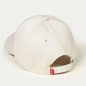 Detail of adjustable strap and metal buckle on off-white cotton baseball cap