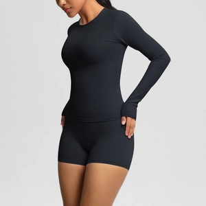 Detail of black long-sleeve workout set with thumbholes and high-waist shorts