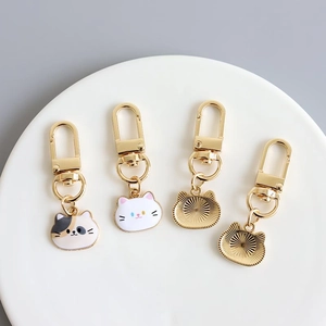 Cute enamel cat keychain set featuring colorful kitten faces with golden metal lobster clasps