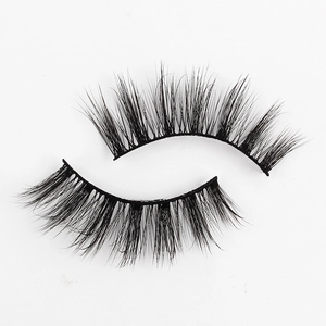Close-up of fluffy 3D faux mink lashes featuring natural curl and dense length on white