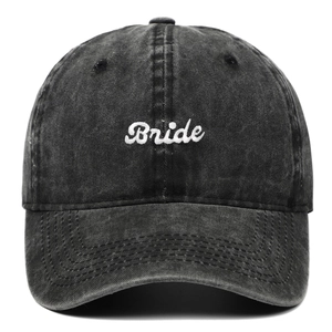 Faded black washed cotton baseball cap with white Bride script embroidery and curved brim