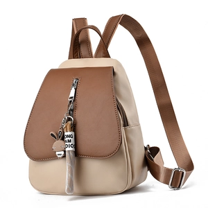 Fashionable color-block mini backpack for women in beige and brown faux leather with charm