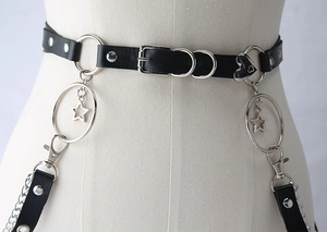 Close-up of gothic leather body chain with star pendants and metallic heart detail