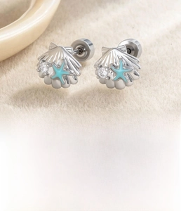 Macro shot of silver seashell stud earring with blue starfish and cubic zirconia