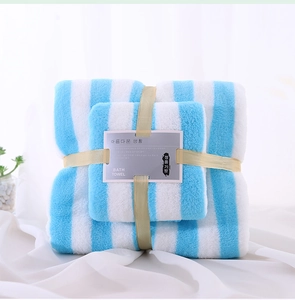 Detailed view of blue and white striped coral fleece towel set with gift ribbon