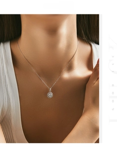 Detailed view of a silver S925 necklace with a sparkling round halo moissanite on a model
