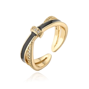 Macro view of crossover gold ring with black enamel lines and micro-pave zircons