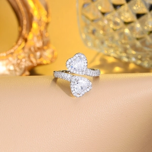 Macro detail of silver double heart open ring featuring sparkling micro-pave cubic zirconia