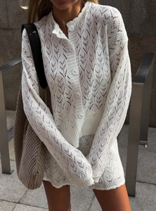 French style white hollow knit two-piece cardigan and skirt set for women in city street