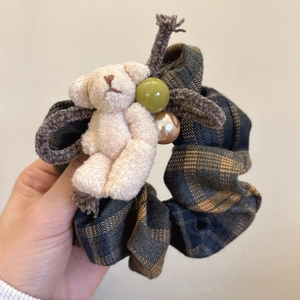 Detail of plaid scrunchie with plush bear, dark blue and brown check fabric hair tie