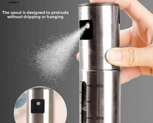 Close-up of glass oil sprayer with measurement scale showing fine mist spray detail