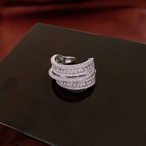 Macro shot of silver multi-layered zircon ring with alternating baguette and round stones