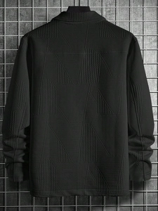 Close-up of black casual jacket featuring geometric jacquard texture and paneled design