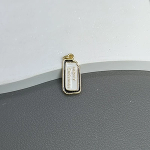 Macro shot of rectangular gold-plated Christmas tree pendant with Merry Christmas text