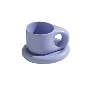 Minimalist purple ceramic coffee mug set with thick handle and matching saucer on white background
