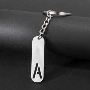 Minimalist silver metal keychain with hollow capital letter A pendant on black background