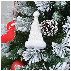 Mini white plush Christmas hat ornament hanging on a snowy festive holiday tree branch