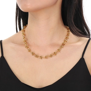 Macro shot of 18k gold plated titanium steel interlocking chain with a knotted detail