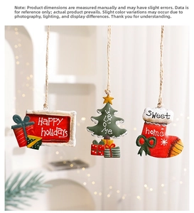 Detailed view of hand-painted metal Christmas ornaments including tree, sock, and gift bag
