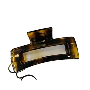 Minimalist large amber tortoiseshell geometric hair claw clip on white background