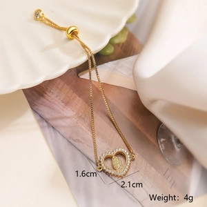 Detail view of gold heart pendant bracelet with Maria cameo and zircon stones, 1.6cm by 2.1cm