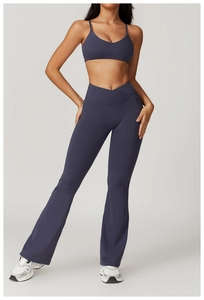 Detail of cross V-shaped high waist and flared legs on dark grey-blue yoga set