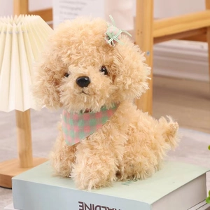 Perro de peluche rizado marrón claro con bufanda de cuadros rosa y verde y un lazo