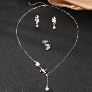 Detailed view of silver leaf jewelry set with pearls including necklace, earrings and ring