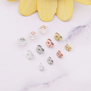 Detailed macro view of S925 sterling silver earring backs in gold and silver finishes
