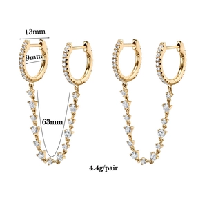 Macro detail of gold-plated zircon earrings with chain length and weight dimensions